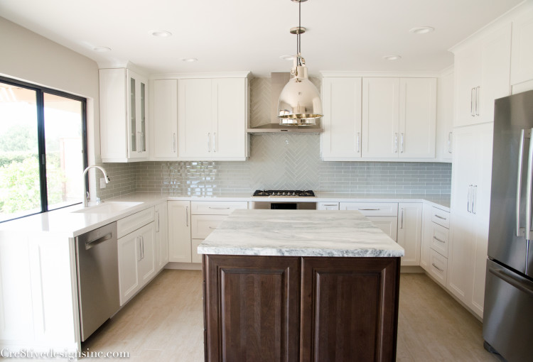 Kitchen remodel with quartz countertops and a honed marble island