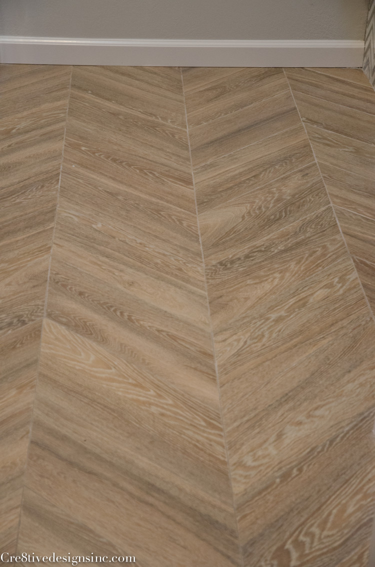 wood look porcelain tiles laid in a chevron pattern